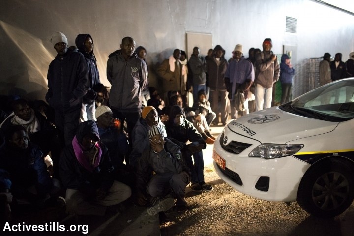 African refugees gather outside the central bus station in the city of Be'er Sheva, after marching from the new detention center 'Holot', close to the Israeli-Egyptian border, protesting the Israeli government's decision to jail them in a new facility, December 15, 2013. 480 refugees were sent on Friday from Saharonim prison to a new center, in which there are allowed to go out during the day time. The group stayed the night at the central bus station, and was provided with food and hot drink by local social activists (Photo: Activestills)
