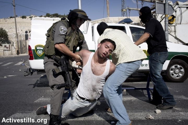 A Palestinian arrested in East Jerusalem, December 2013, by masked police officers (Photo: Activestills)