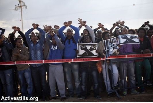 African asylum seekers take part in a protest outside the Holot detention center, in Israel's southern Negev desert, February 17, 2014. The protesters called to close the prison and to recognize the refugee rights of the African asylum seekers living in Israel.