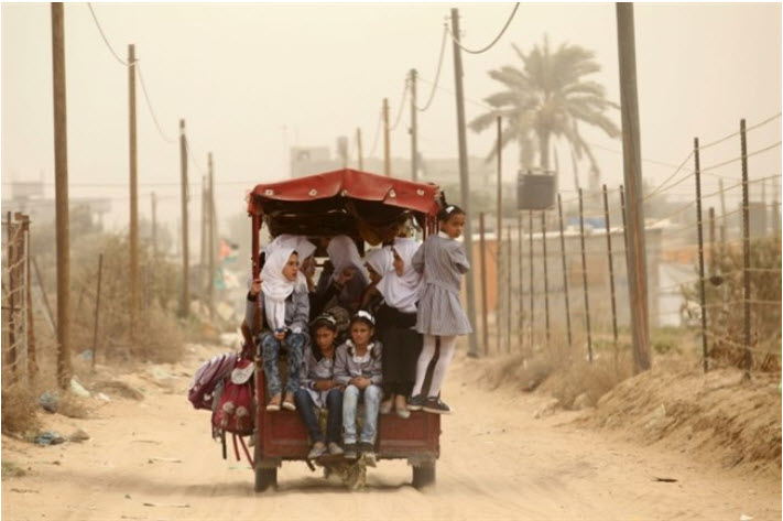 Palestinian school children ride a rickshaw in Khan Younis in the southern Gaza Strip on September 9, 2015.