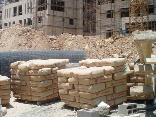 Bags of Nesher cement at a construction site in the Har Homa settlement neighborhood in occupied East Jerusalem