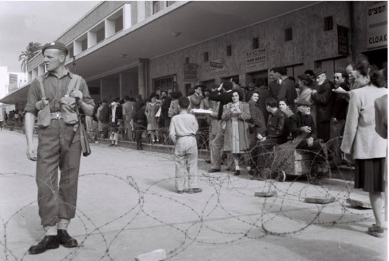 A British soldier guarding the fenced off Tel Aviv central bus station during a curfew imposed under martial law in 1947. Israel’s new Terror Law is based on imperialist British Mandatory emergency statutes in Palestine.