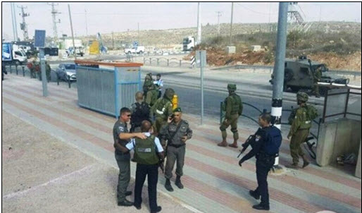 Israeli forces gather at the Za'atara checkpoint after a Palestinian woman, Rahiq Birawi, was shot and killed by border police on October 19, 2016.