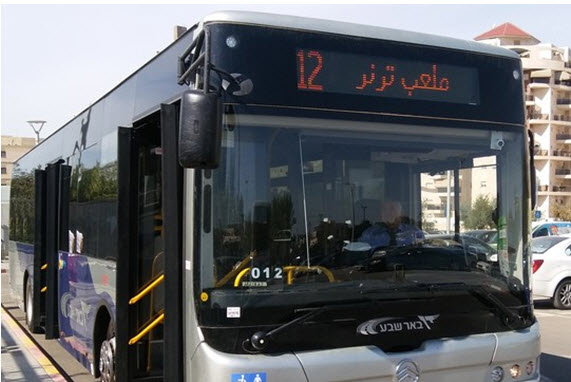 A Dan bus in Be'er Sheva outfitted to display and announce station names in both Hebrew and Arabic.  The final destination of bus line 12 is the Turner (Football) Stadium.