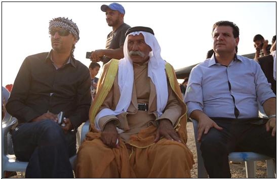 MK Odeh (first from right) with al-Araqib Sheikh Siah al-Touri (center) during a meeting with dozens of activists and residents held in the village to commemorate the 7th anniversary of the village’s first demolition, August 17, 2017