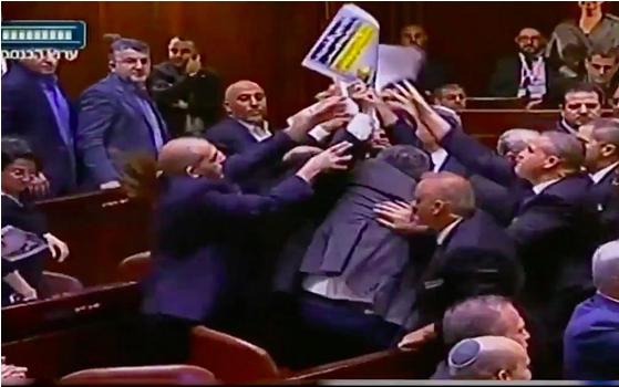 Ushers brawl with Joint List lawmakers to take away the latter’s signs declaring "Jerusalem is the capital of Palestine” before ousting them from the Knesset plenum during US Vice President Mike Pence’s speech in Jerusalem on January 22, 2018.