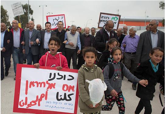 MK Odeh (background, fourth from left) marches during a demonstration against the eviction of Umm al-Hiran residents from their homes. Earlier this month the Arab-Bedouin residents of this “unrecognized village” signed an agreement to dismantle their homes after years of struggle, only the latest manifestation of the continuing Nakba which Odeh refers to in this op-ed. 