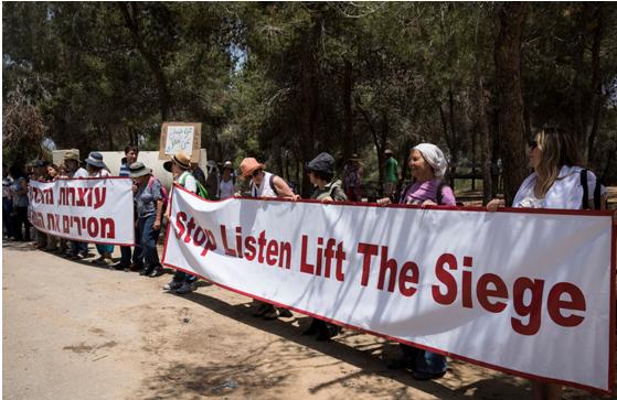 Israeli peace demonstrators near the Gaza border call for an end to the siege of Gaza, Friday, May 11, 2018.