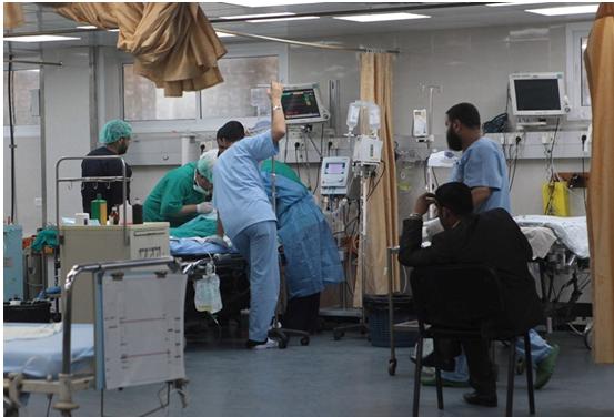 Hospital physicians in Gaza treating an injured man