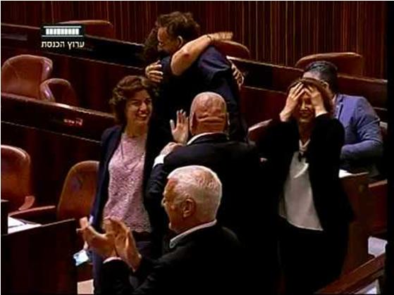 Members of the opposition cheer and congratulate one another after the bill was approved by a vote of 37 to 36.