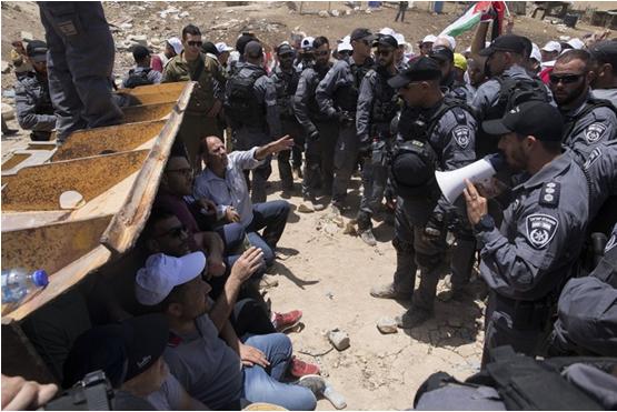 Israeli police officers and occupation soldiers confront demonstrators in Abu al-Nuwwar
