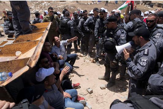 Protesters demonstrate at Khan al-Ahmar against the pending eviction of the West Bank village, July 4, 2018.
