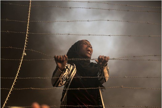 A young Palestinian woman demonstrating near the fence in the Gaza Strip, Friday, September 28