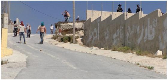 Hooded Israeli settlers assault 'Urif while military looks on, covering them, July 6, 2018