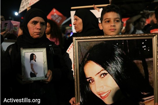Relatives of the late Samer Khatib, a victim of male violence, display photographs of her during the mass rally held in Rabin Square in Tel Aviv on Tuesday night, December 4.