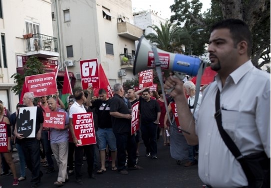Newly appointed Haifa Deputy Mayor Raja Zaatry (right) addresses participants in a march in the northern city demonstrating against the occupation of the Palestinian territories.