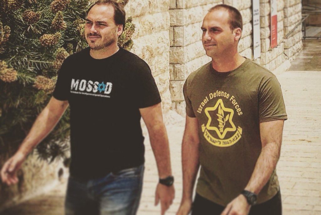 Militaristic machismo: Jair Bolsonaro’s two sons, Eduardo and Carlos, during their trip to Israel in May 2016. Eduardo, right, posted to social media this photo of himself and his brother sporting Israel army and Mossad T-shirts. 