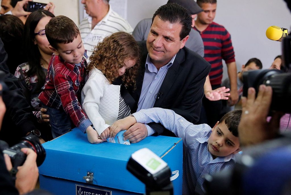 Ayman Odeh casting his ballot with his young family on March 17, 2015, in the general elections for the 20th Knesset