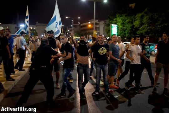 Lehava-Kach members attacking a demonstration against Israel's brutal Protective Edge military campaign in Gaza that was held at the Habima Square, Tel Aviv, July 2014 (Photo: Activestills) 