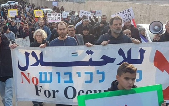 Demonstrators march in occupied East Jerusalem to protest the eviction of the Palestinian Sabbagh family from its home in Sheikh Jarrah.