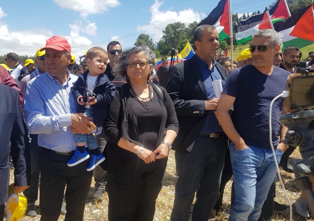 Hadash Secretary General Mansour Dahamshe (first from left) and MK Aida Touma-Sliman (center) during the Nakba Day march to Khubbayza