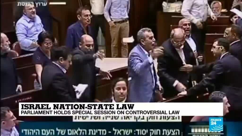 MKs from the Joint List vociferously protest the proceedings of the Knesset session during which Israel's parliament voted to pass the racist Nation-State Law in its second and third readings, enacting it as law, July 18-19, 2018.