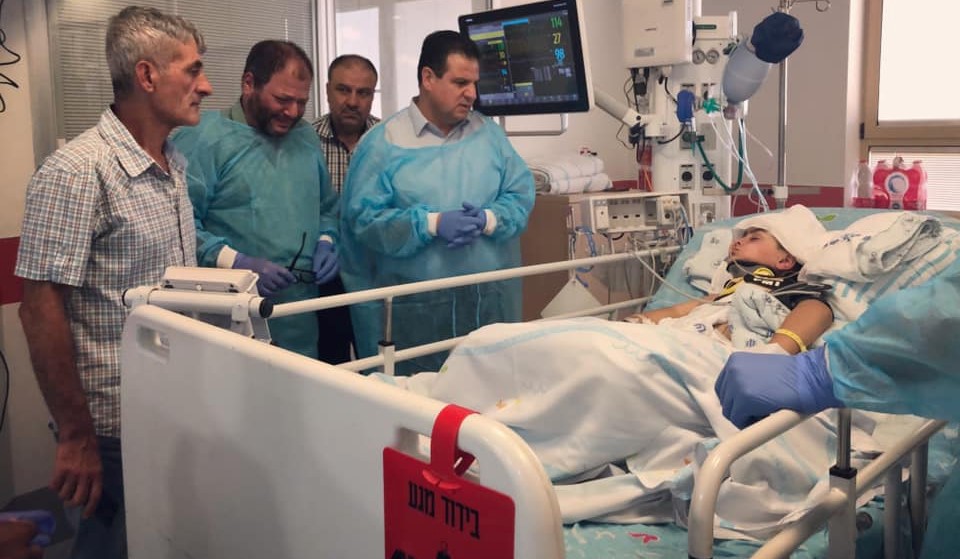 MK Ofer Cassif (second from left), in tears, beside MK Ayman Odeh, during their visit to the bedside of Abd Rahman Shteiwi in the intensive care unit at Sheba Hospital in Tel Hashomer, Saturday, July 20