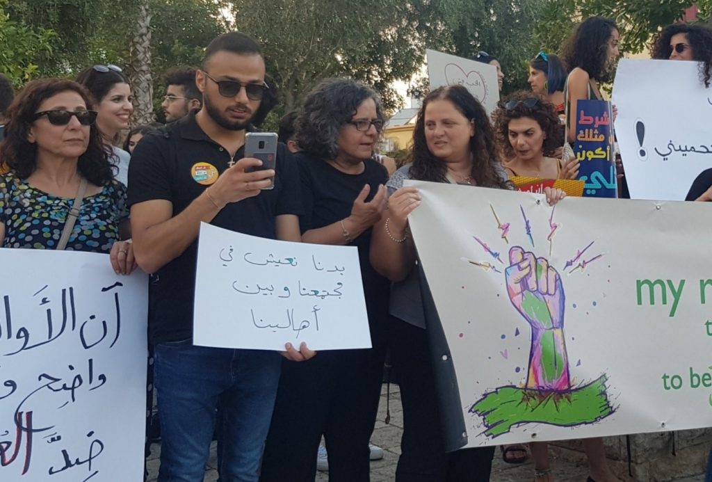 MK Aida Touma-Sliman (third from left) during the Arab-Palestinian LGBT community protest held in Haifa last Thursday, August 1; the small sign in the center reads: "We want to live within our society and according to our own wills."