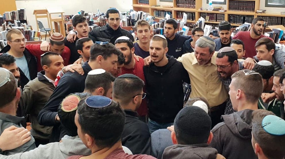 Current Education Minister Rafi Peretz (right, in the inner ring, dressed in a beige shirt) with Otzem Pre-Military Torah Academy students when he headed-up that school