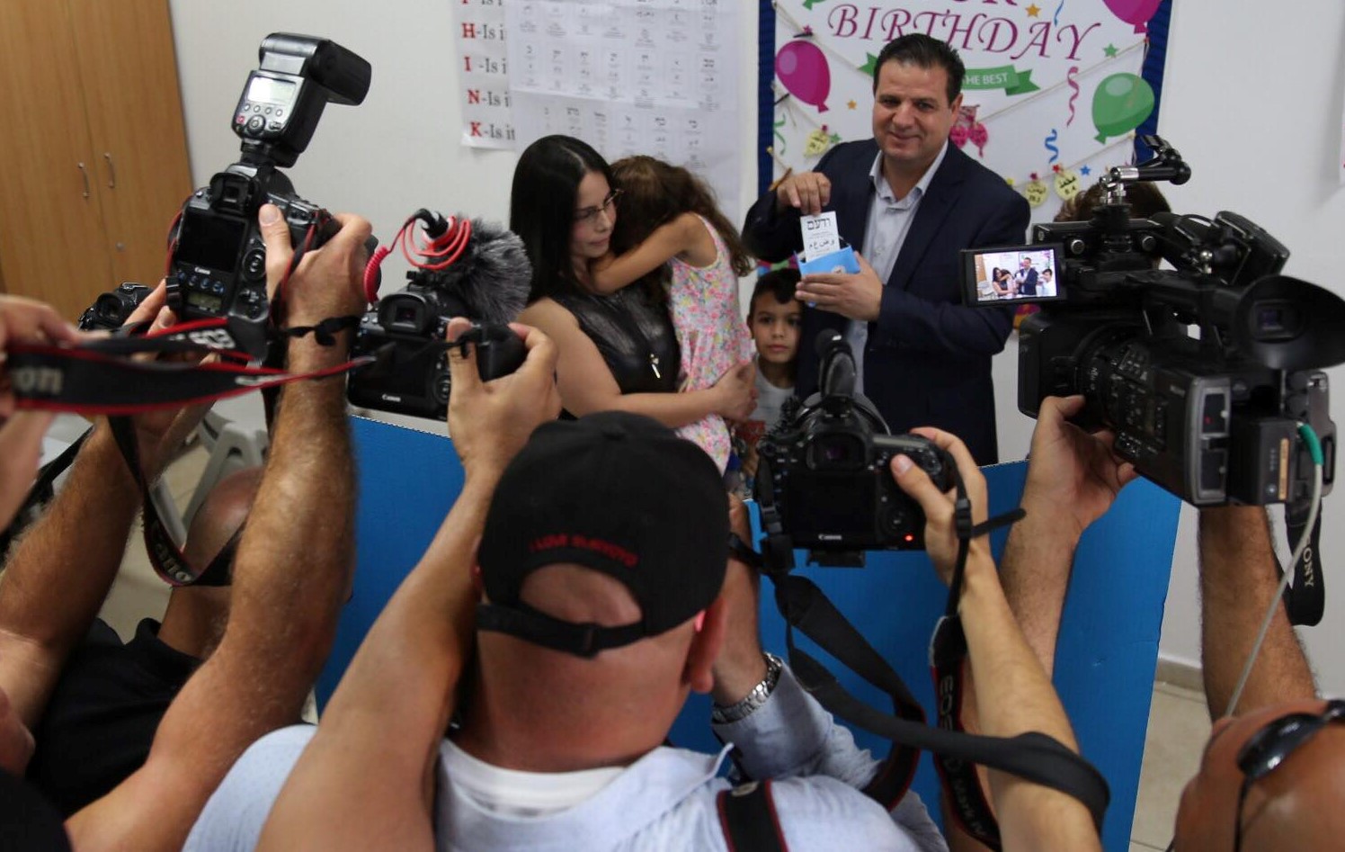 Joint List leader, MK Ayman Odeh (Hadash), accompanied by his young family, casts his ballot in Haifa on Tuesday morning, September 17.