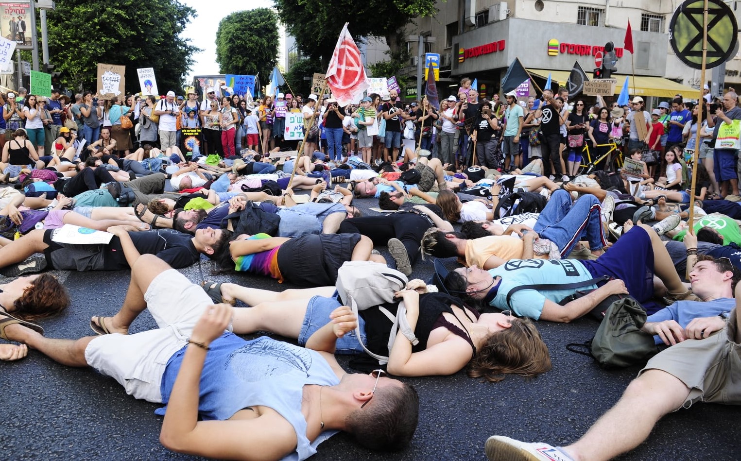 During the Friday, September 27, protest march in Tel Aviv, dozens of teenagers lay down on Allenby Street to symbolically depict humanity's fate unless the climate crisis is seriously addressed by governments and the economies around the work.