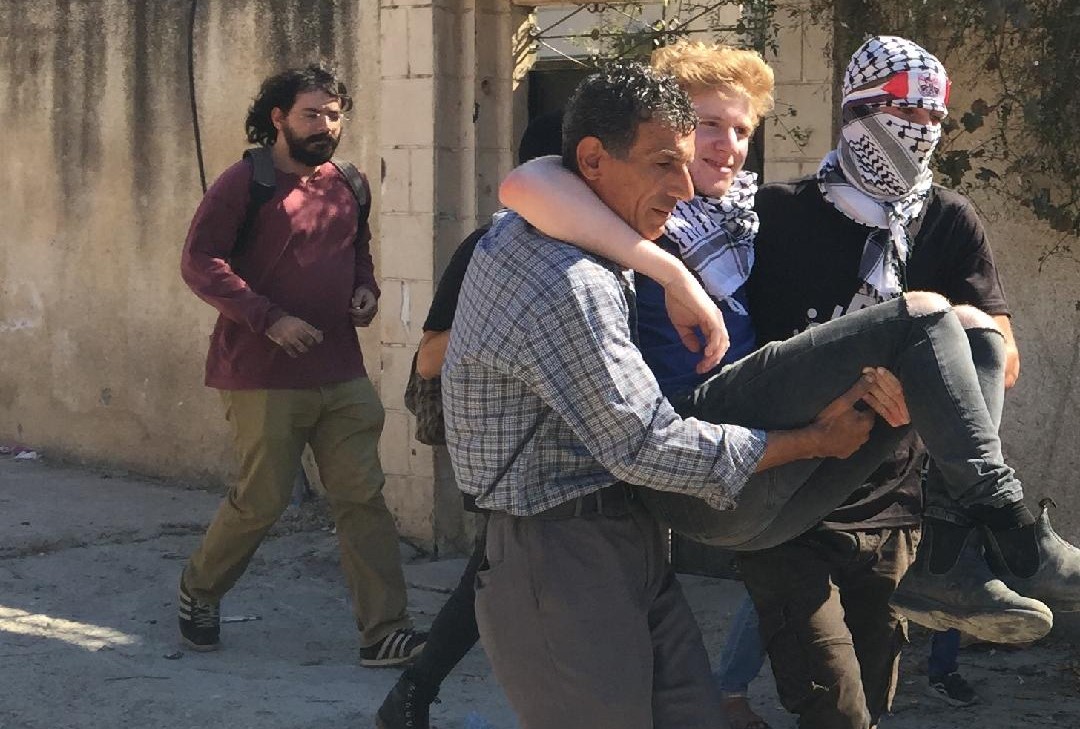 One of the two Israeli Communist demonstrators injured at Kafr Qaddum is evacuated by Palestinians, last Friday October 4.