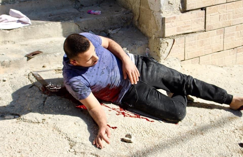 Seemingly stunned and in disbelief, a mortally wounded Omar Haitham al-Badawi wallows in his own blood just after being hit by Israeli gunfire in the Al-'Arrub refugee camp on Monday, November 11, 2019. The 22-year-old al-Badawi died shortly afterwards in hospital in Hebron.