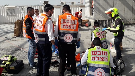Paramedics unsuccessfully attempt to save the life of Samir Karamawi, 23, who was critically injured in after he fell from a height of several meters at a construction site at the Big Center in Yehud, November 7, 2019. Karamawi was the 42nd construction worker to die in a workplace accident during 2019. 