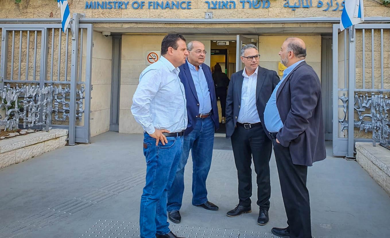 Hadash’s Ayman Odeh, Ta’al’s Ahmad Tibi, Balad’s Mtanes Shehadeh, and Ra’am’s Mamsour Abbas, the leaders of the four parties comprising the Joint List, confer outside the Ministry of Finance in Jerusalem, October 2019.