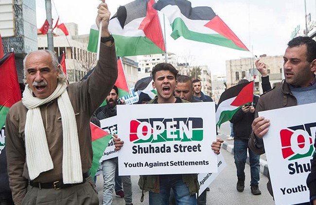 Palestinians demonstrate against the Jewish settlement in Hebron.