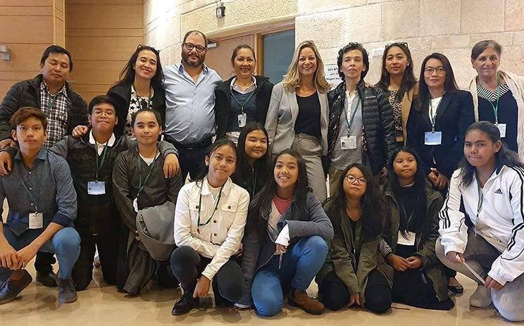 Hadash MK Ofer Cassif (standing, third from left) at the Knesset with migrant workers and their Israel-born children on Wednesday, December 4 