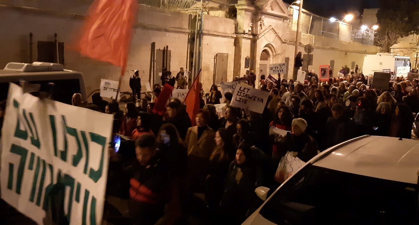 Hundreds of Israeli and Palestinian activists demonstrate outside police headquarters at Jerusalem’s Russian Compound on Saturday night, December 7, in solidarity with the residents of Isawiya. The large banner at the extreme left reads: "We are all with Isawiya."