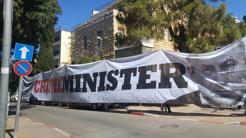 "Crime Minister," a banner displayed by protestors near Prime Minister Benjamin Netanyahu's official residence on Balfour Street in Jerusalem