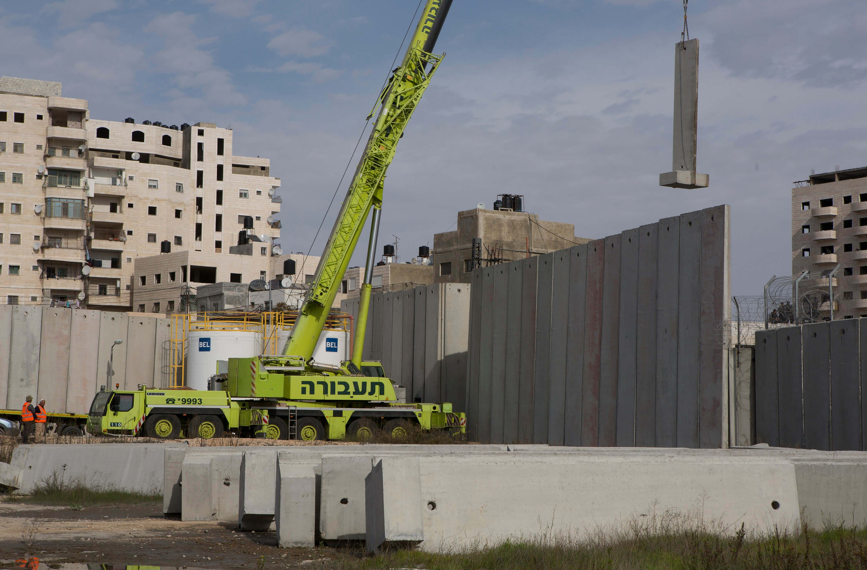 Capital and Rule: Heavy equipment belonging to Taavura, the largest road haulage and logistics company in Israel, works on the expansion of a checkpoint at the Shuafat refugee camp in occupied East Jerusalem, June 2014.