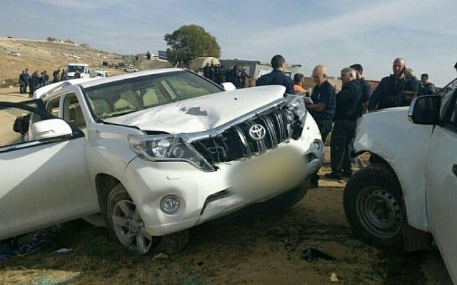 Israeli police stand next to the vehicle belonging to Yaqoub Mousa Abu al-Qee’an that rammed into officers in the Arab-Bedouin village of Umm al-Hiran in the Negev desert, January 18, 2017. 