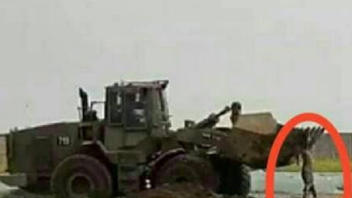 An Israeli military bulldozer abducts the body of Muhammed Ali al-Na'im, preventing other Palestinians from recovering it. 