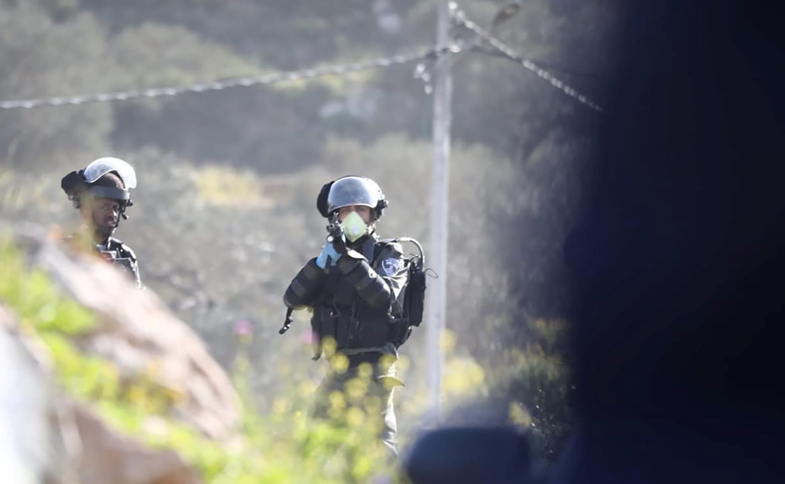 Israeli forces fire at Palestinians on Jabal al-'Arma, last Wednesday, March 11.