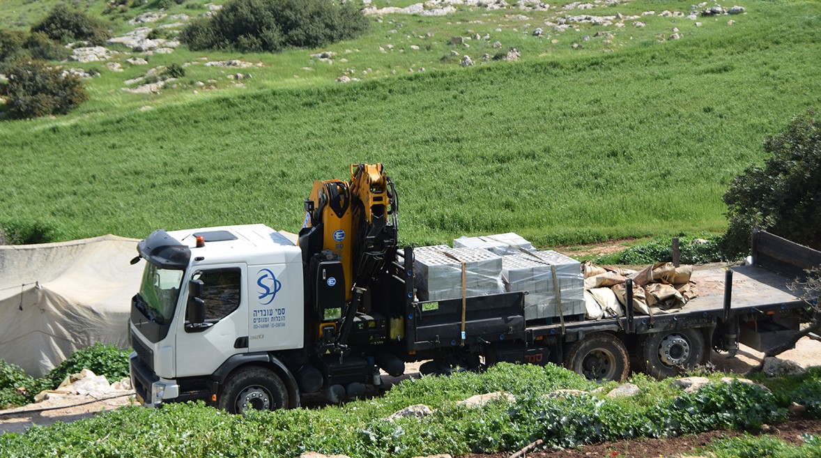 Crimes against humanity: One of two flatbed trucks sent by Israel's Civil Administration to confiscate tents and building materials that were to used to protect residents from the village of Khirbet Ibziq from the spread of COVID-19, Thursday, March 26, 2020