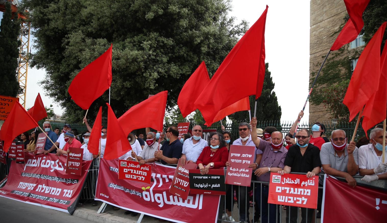 Members of Hadash and the Communist Party of Israel protest near the Knesset, on Thursday evening, May 14.