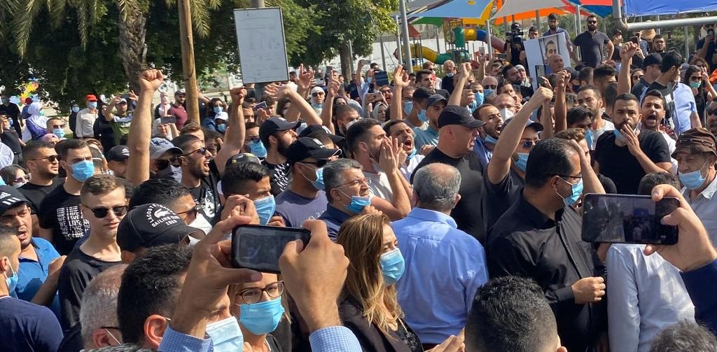 Hadash MK Youssef Jabareen (center) stands among demonstrators in Arara on Thursday, May 14, protesting the shooting death of Mustafa Younis, 26, a young Arab man with a history of organically caused psychiatric problems, who was shot to death while disarmed and prone after he had stabbed and slightly wounded one of a number of a number of security guards who assaulted him as he attempted to leave Sheba Medical Center.