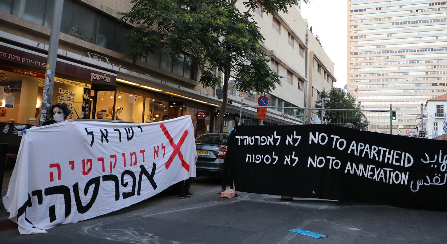 Leftist activists blocked Herzl Street in Tel Aviv last Sunday, June 14, to protest Israel's imminent annexation of the occupied Palestinian territories. The white banner to the left reads: "Israel is not a democracy… Apartheid."