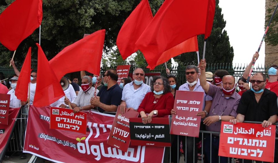 Members of Hadash and the Communist Party of Israel demonstrate against the annexation and occupation of the Palestinian territories outside the Knesset, May 14, 2020. First from right is MK Ofer Cassif, whose Hadash sign reads "Opposing the Occupation."