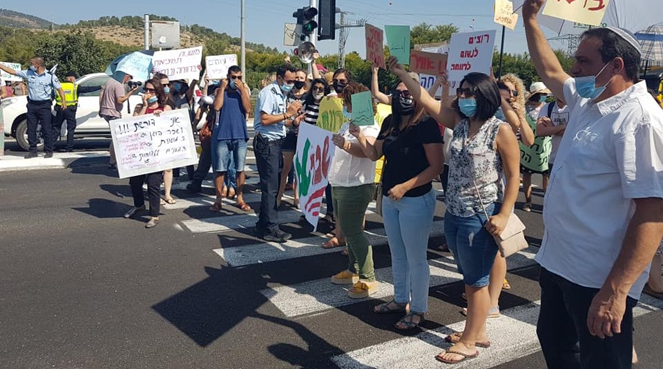 Social workers block traffic at the Mahanaim Junction in the Upper Galilee on Monday morning, July 13.