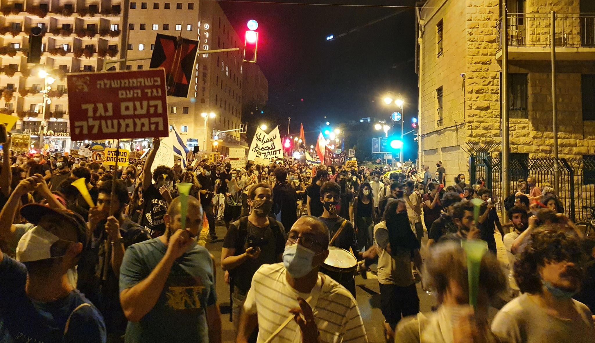 Thousands of Israelis protested against Prime Minister Benjamin Netanyahu in Paris Square near his official residence in Jerusalem, Saturday July 18. The red Hadash placard in the foreground reads: "When the government is against the people, the people are against the government."